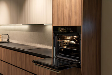 Spacious built-in oven with open door, ready for cooking and baking