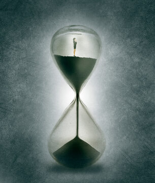 Businesswoman standing inside hourglass