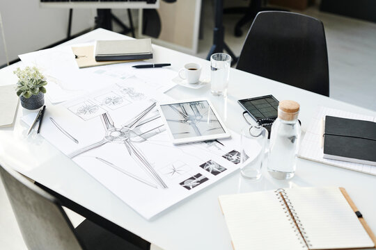 Blueprint and office supplies kept on table