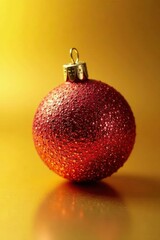 Close-up of a single glittering Christmas ornament on a gold surface , close-up, greeting card background, merry christmas