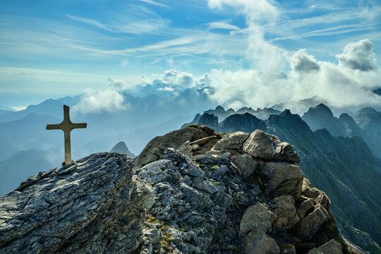 Religious cross on Brandberger Kolm mountain with Zillertal Alps in background