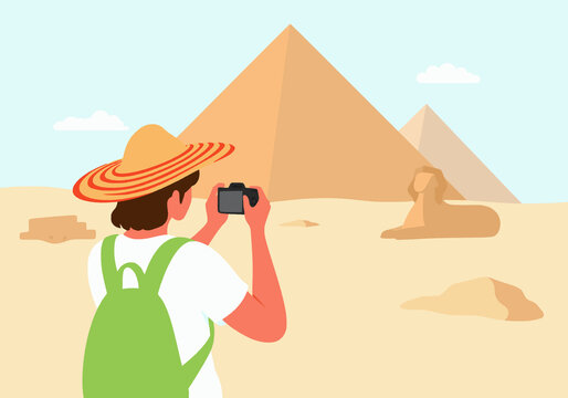 Woman photographing Giza pyramids and Sphinx in Cairo, Egypt