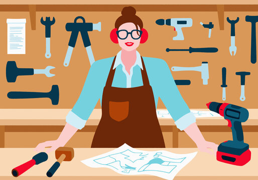 Carpenter with instruction manual and tools at work bench