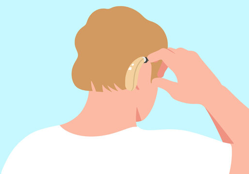 Man adjusting hearing aid against blue background