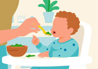 Hand of parent feeding child sitting on high chair