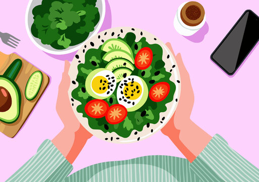 Person holding bowl of fresh salad