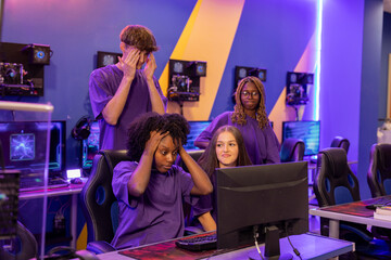 Frustrated gamers covering faces during video game tournament in internet cafe © PintoArt