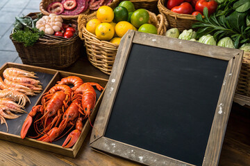 Fresh seafood. A wide range of shrimp, lobsters, octopus and other marine life. On a black chalkboard.