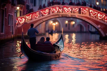 Fototapeten Couple enjoying a gondola ride under a bridge illuminated with heart-shaped Valentine’s Day lights © gankevstock