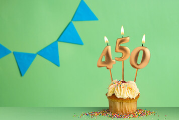 Candles forming the number 450 - Green background