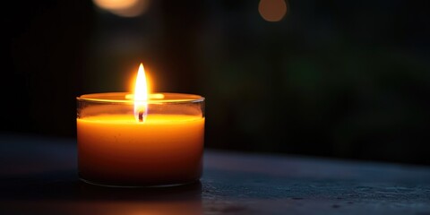 A single candle burning in a quiet, somber setting, symbolizing grief and remembrance.