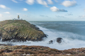 Strumble Head Lighthouse on the Pembrokeshire Coast in Wales during high winds