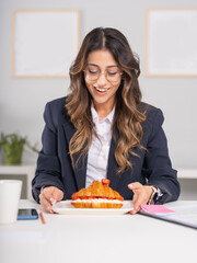 Lunch break at office, happy young caucasian businesswoman taking lunch break at office. Looking...
