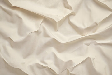 Beige wrinkled paper background recycled from paper packaging. The paper is a light beige color.