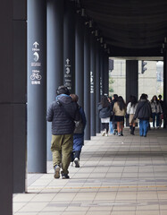 冬の昼の大阪市の繁華街で歩く人々の観光客の姿