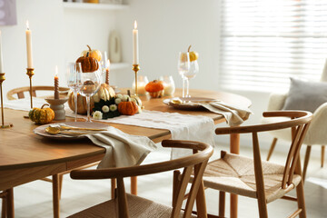 Stylish dining room with beautiful table setting and autumn decor