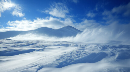 Snowy Mountain Landscape with Windblown Snow and Blue Skies