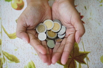 Thai currency is Bath in woman's hand