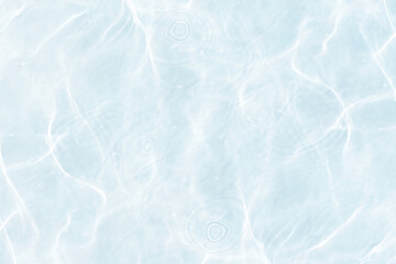 Fototapeta premium Blue water with ripples on the surface. Defocus blurred transparent blue colored clear calm water surface texture with splashes and bubbles. Water waves with shining pattern texture background.