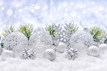 Christmas composition with festive decorations on the snow. Christmas or New Year greeting card.