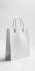 White paper shopping bag with handles on light gray background