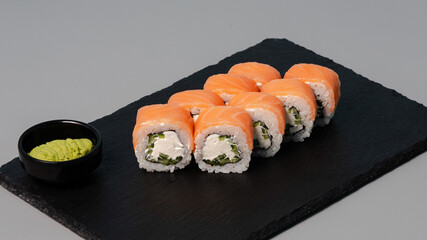 Sushi rolls on black tray