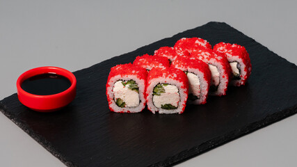 Sushi rolls on black tray