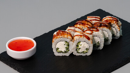 Sushi rolls on black tray
