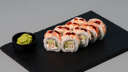 Sushi rolls on black tray