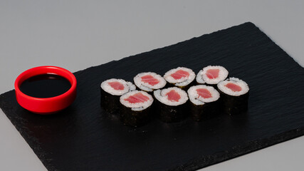 Sushi rolls on black tray
