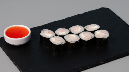 Sushi rolls on black tray