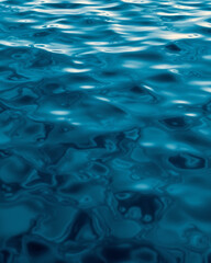 Obraz premium Abstract Blue Water Surface with Ripples and Reflection background 