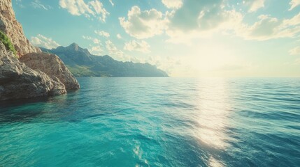 Fototapeta premium Tranquil ocean landscape with serene waters, rocky coastline, and gentle sunlight reflecting on the surface under a clear sky.