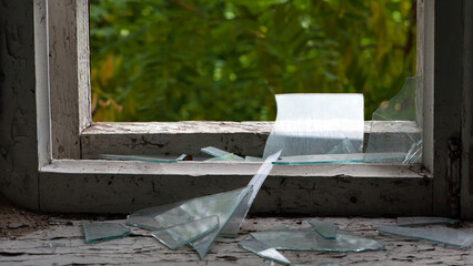 Smashed glass Window with old wooden frame. old window. finely broken glass. old house, retro....