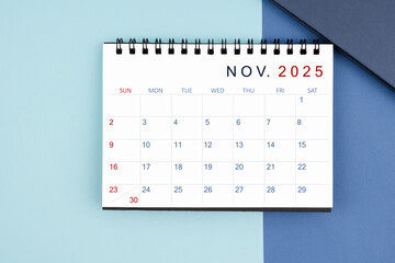 November 2025 monthly desk calendar for 2025 year on blue background.