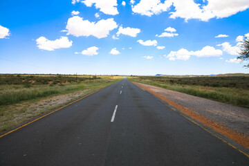 The Trans-Kalahari Corridor is a paved highway corridor that provides a direct connection from the port of Walvis Bay and Windhoek in central Namibia. Endless long asphalt road. Namibia Africa.