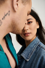 Young couple shares an intimate moment in a studio, selective focus on woman