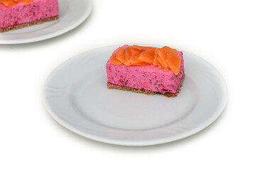 Delightful beetroot mousse with salted salmon slices on a white plate