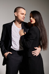 A fashionable young couple showcasing their romance in a studio, embodying Valentines spirit.