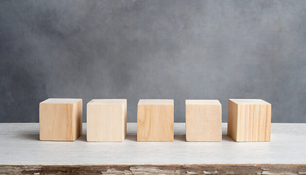 5 wooden cubes on gray backdrop. Wood blocks. Place for adding text or design. Mock-up.