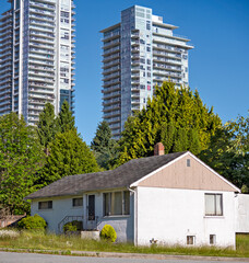 Old residential house on new high-rises background