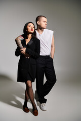 A stylish couple poses together in a studio, celebrating their love for Valentines Day.