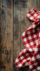 Obraz premium Red and white checkered cloth on rustic wooden table with fresh herbs nearby
