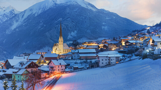  Winter ski sport activities in sunny day. Skier village Wenns bi night. Detail panorama with copy space concept.