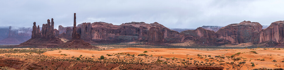 Super wide pano of Totem Pole in Monument Valley Arizona during a gray, stormy day. © cherylvb
