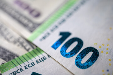 100 dollar bills and 100 euro bills close-up symbolize wealth, international finance, currency exchange and world economy, world currency market, competitors