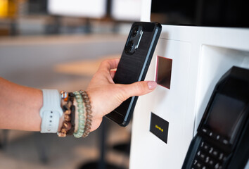 Girl Uses Smartphone To Scan Qr Code At Self-Service Terminal