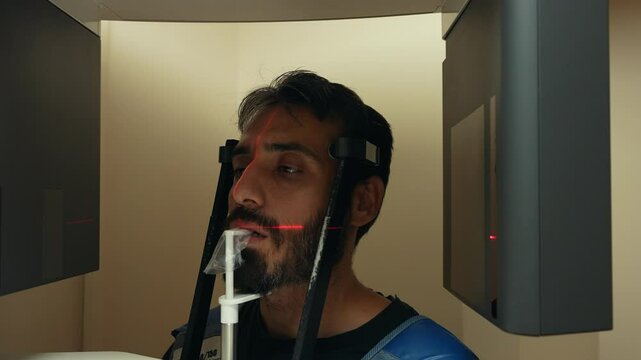 This video shows the imaging process on a dental tomography (CBCT) machine. The camera moves closer to the person being imaged.