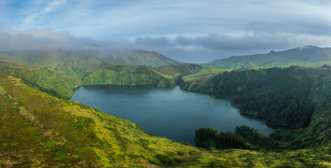 Obraz premium Aerial view on the crater lake lagoa Funda in a volcanic caldera on the isle of Flores, Azores archipelago Portugal