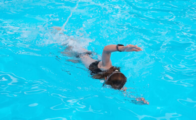 Young Girl Perfecting Front Crawl In Hotel Pool
